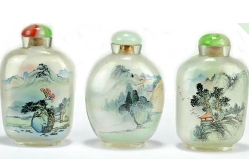 Three Chinese internally painted glass snuff bottles, each decorated with landscapes.