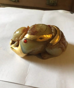 An unusual Chinese possibly gold mounted jade crouching figure.