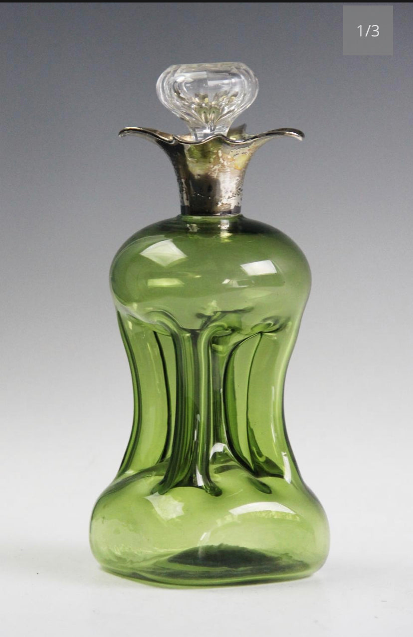 An Edwardian silver mounted green glass glug decanter, William Comyns London 1905