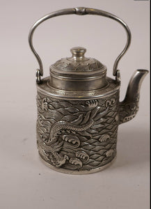 A 19th century cylindrical Chinese silvered metal teapot and cover..