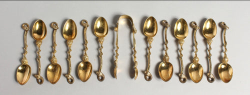 Serpent & Lion Edwardian Set of twelve silver gilt coffee spoons and pair of sugar tongs..