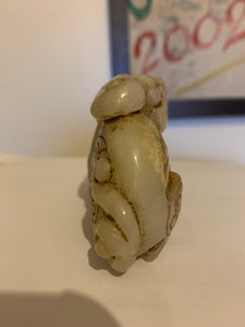 A nephrite/jade carving of a foo dog..
