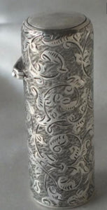 A Victorian cylindrical scent Bottle, attractive scroll engraved. London 1884 By CM..