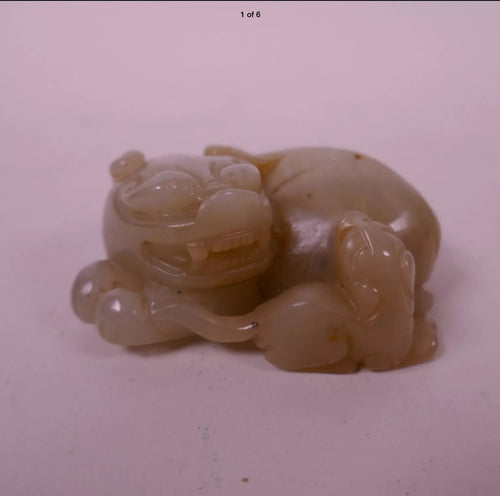 A small Chinese jade figure of a Buddhist lion with  cub.