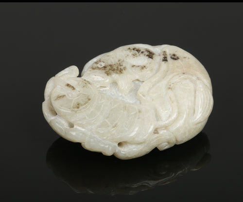 Oval Chinese carved nephrite amulet depicting a figure with a phoenix, bat, carp and string of coins.