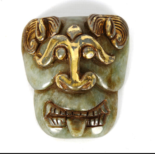 An archaistic Taotie jade buckle with gold gilding