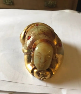 An unusual Chinese possibly gold mounted jade crouching figure.