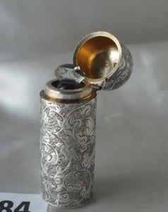 A Victorian cylindrical scent Bottle, attractive scroll engraved. London 1884 By CM..