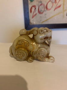 A nephrite/jade carving of a foo dog..