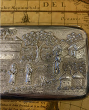 Load image into Gallery viewer, Indian silver cushioned rectangular cigar case , showing Figures In A Village thene .with buildings , trees and houses