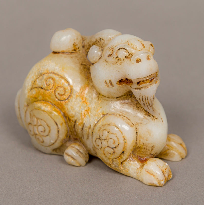 A nephrite/jade carving of a foo dog..