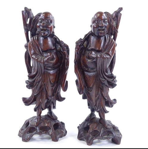 A pair of 19th century oriental carved hardwood figures, possibly Chinese or Japanese.