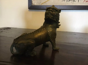 a statue of a dog sitting on a chair 