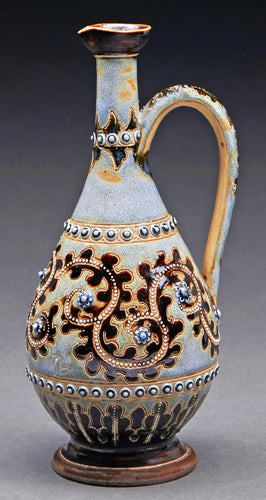 A Doulton ware ewer, 1875, decorated by George Tinworth with beaded bronze and rosettes