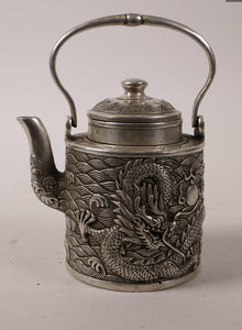 A 19th century cylindrical Chinese silvered metal teapot and cover..