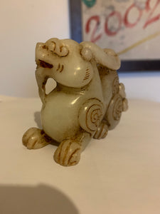 A nephrite/jade carving of a foo dog..